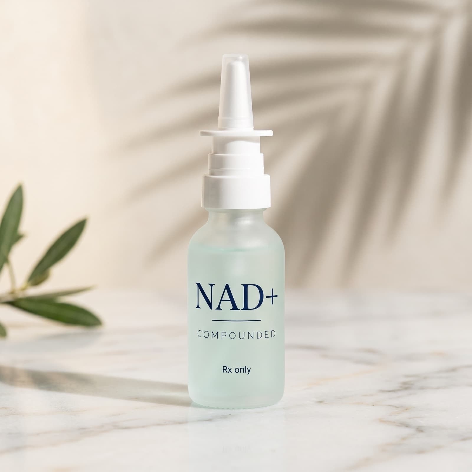 Illustration of a compounded NAD+ nasal spray bottle on white marble